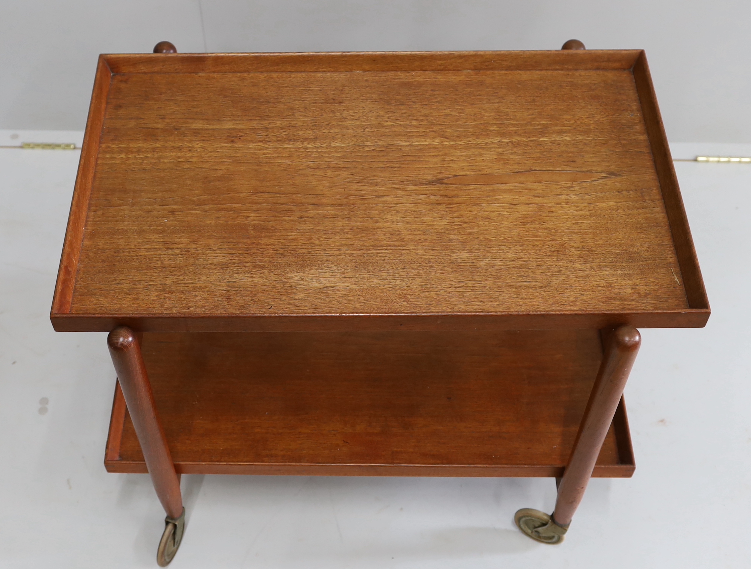 In the manner of Poul Hundevad, a mid century teak two tier tea trolley, width 75cm, depth 50cm, height 59cm